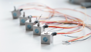 multiple actuators from DCUBED with wiring in a diagonal row into the distance out of focus